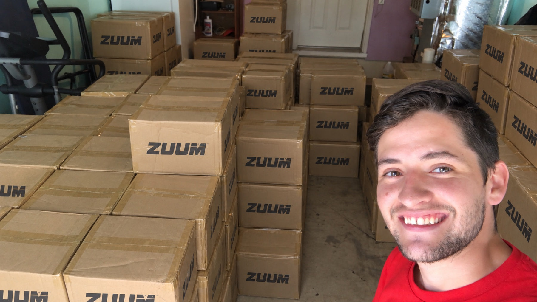 Zuum founder in the original garage surrounded by packed Zuum orders